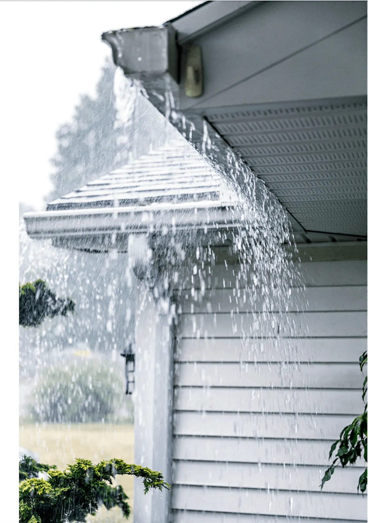 Salt air corrosion damage on a coastal Galveston gutter system showing seam failure and bracket rust