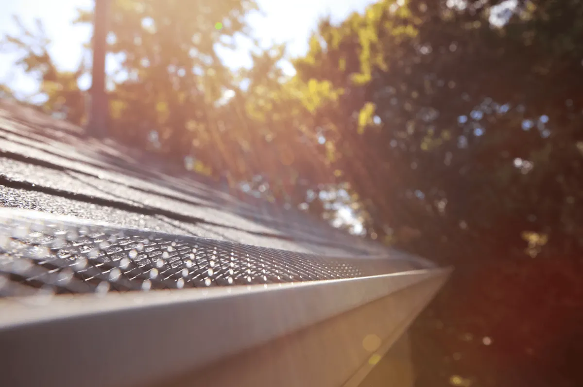 Close-up of marine-grade stainless steel micro-mesh gutter guard showing the fine mesh pattern that blocks debris while allowing water flow